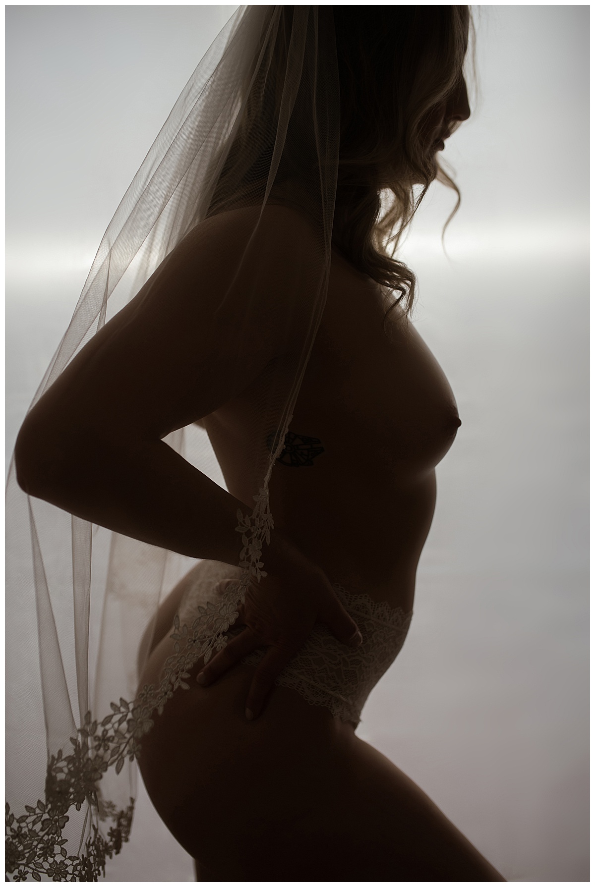 Adult wears wedding veil during her Bridal Boudoir session