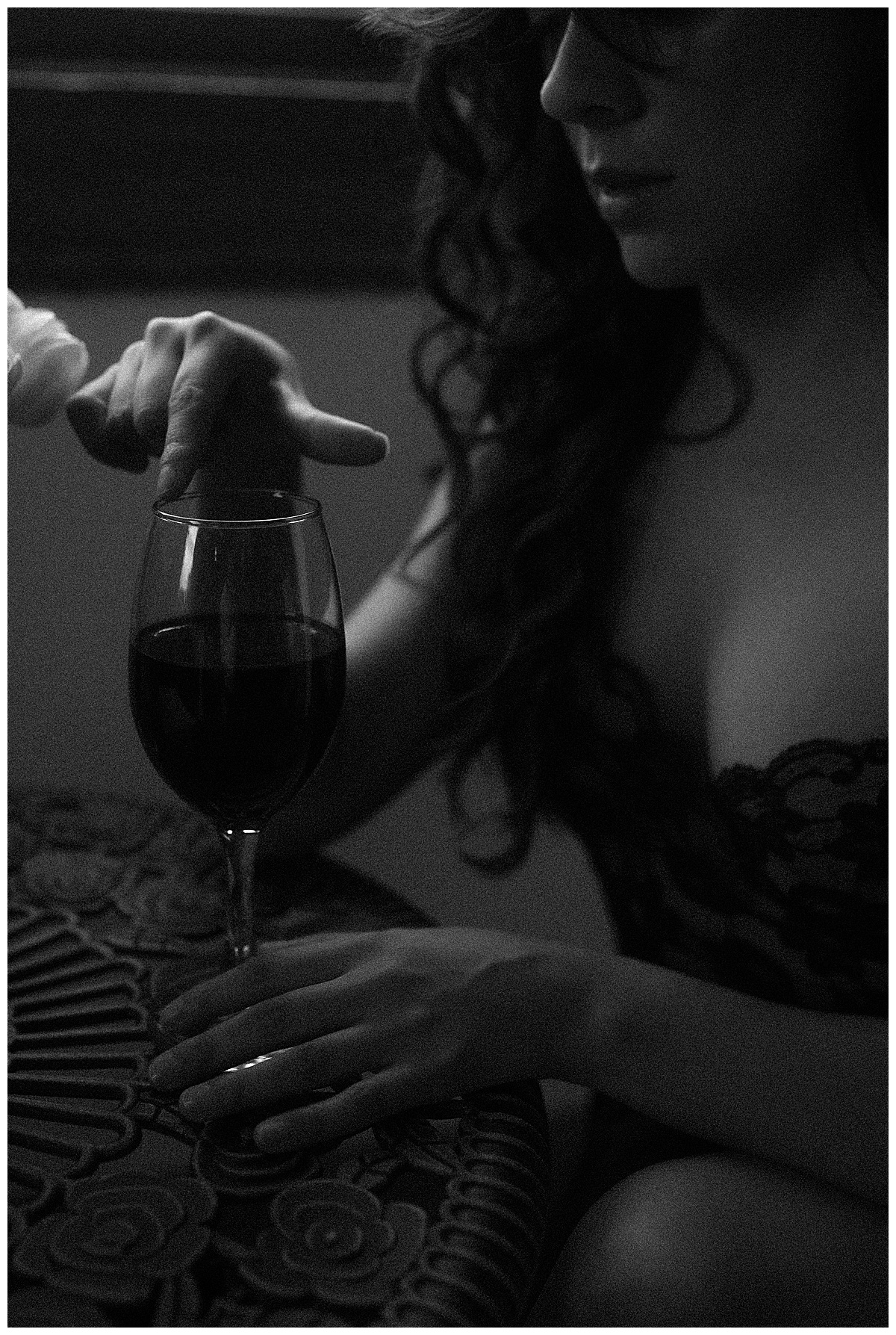 Female plays with wine glass for Colorado Boudoir Photographer