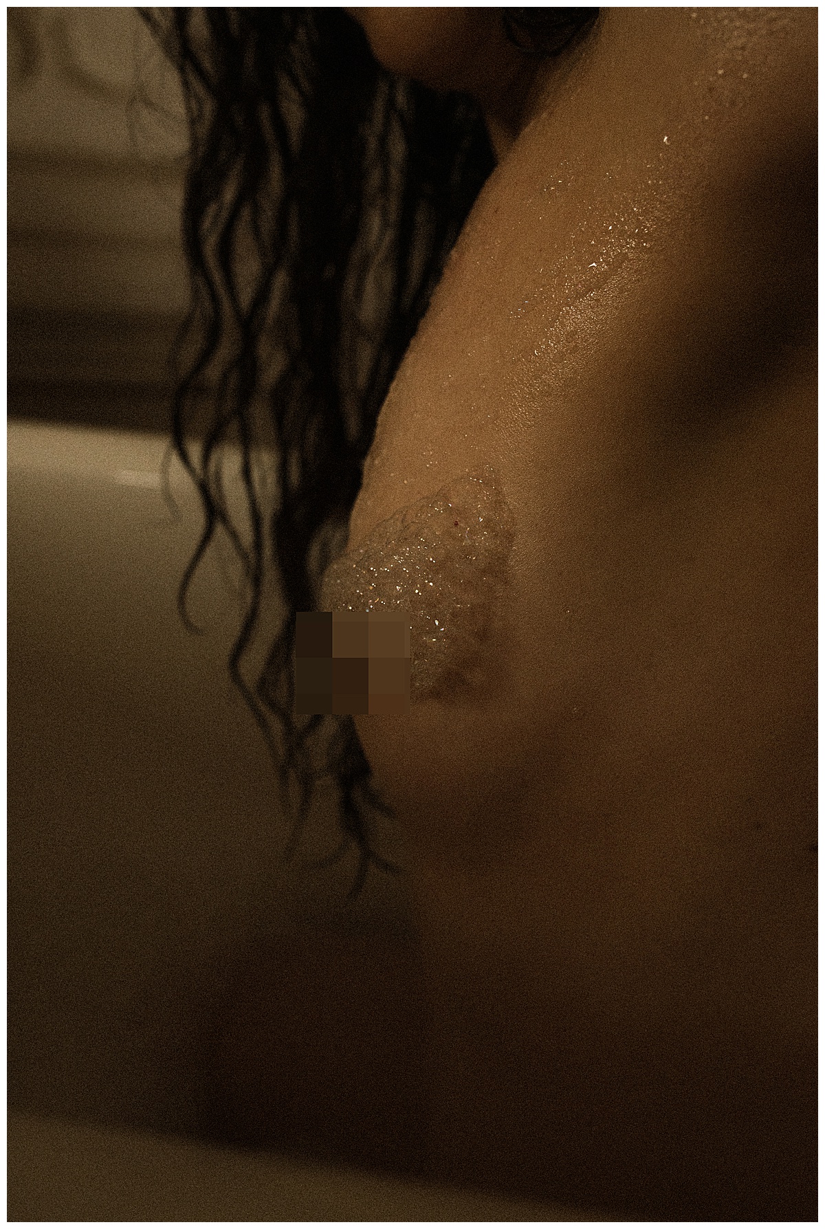 Female has bubbles on her chest for Colorado Boudoir Photographer