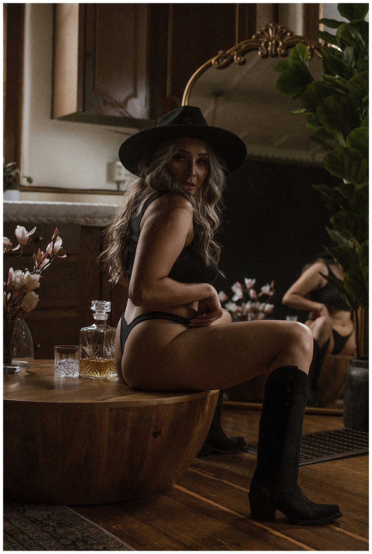 Female sits on the edge of table for Colorado Boudoir Photographer