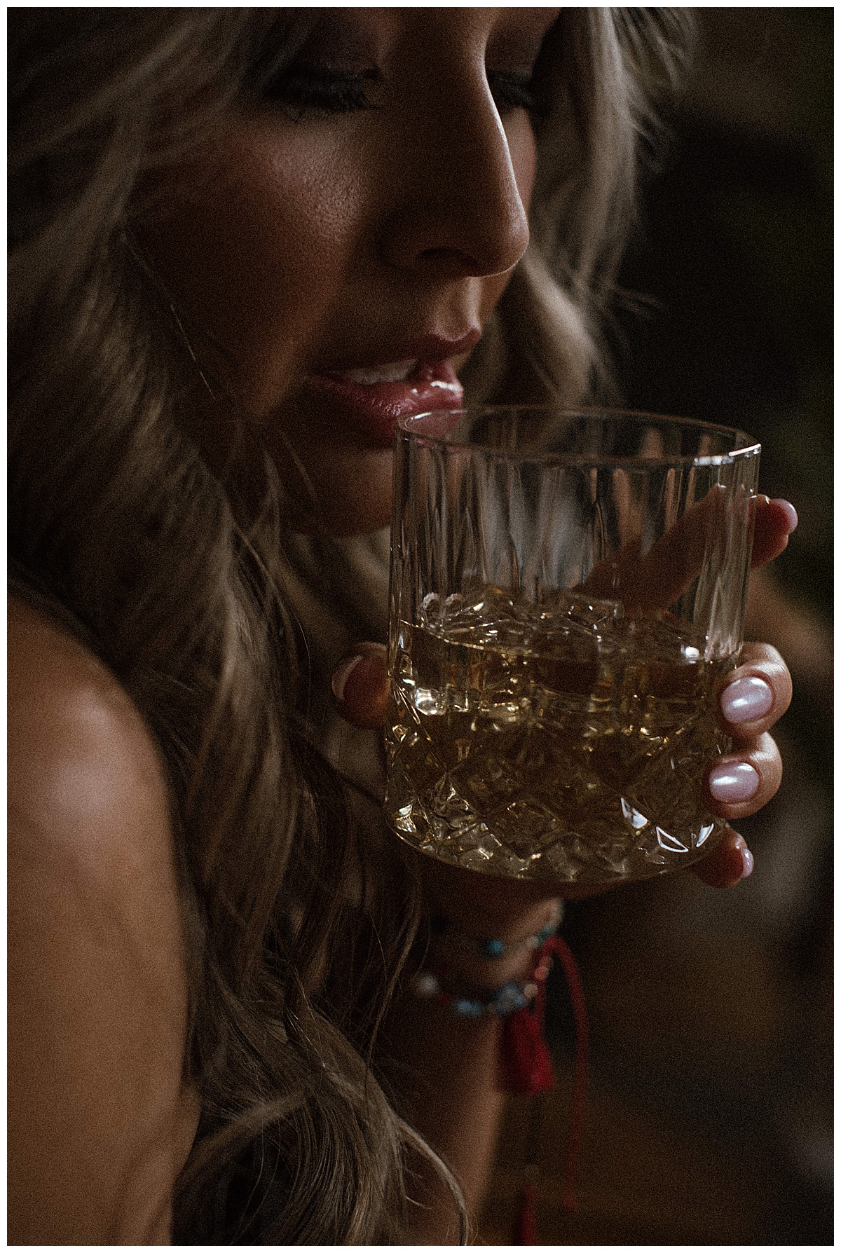 Adult takes a sip from a glass for Melissa Brielle Boudoir