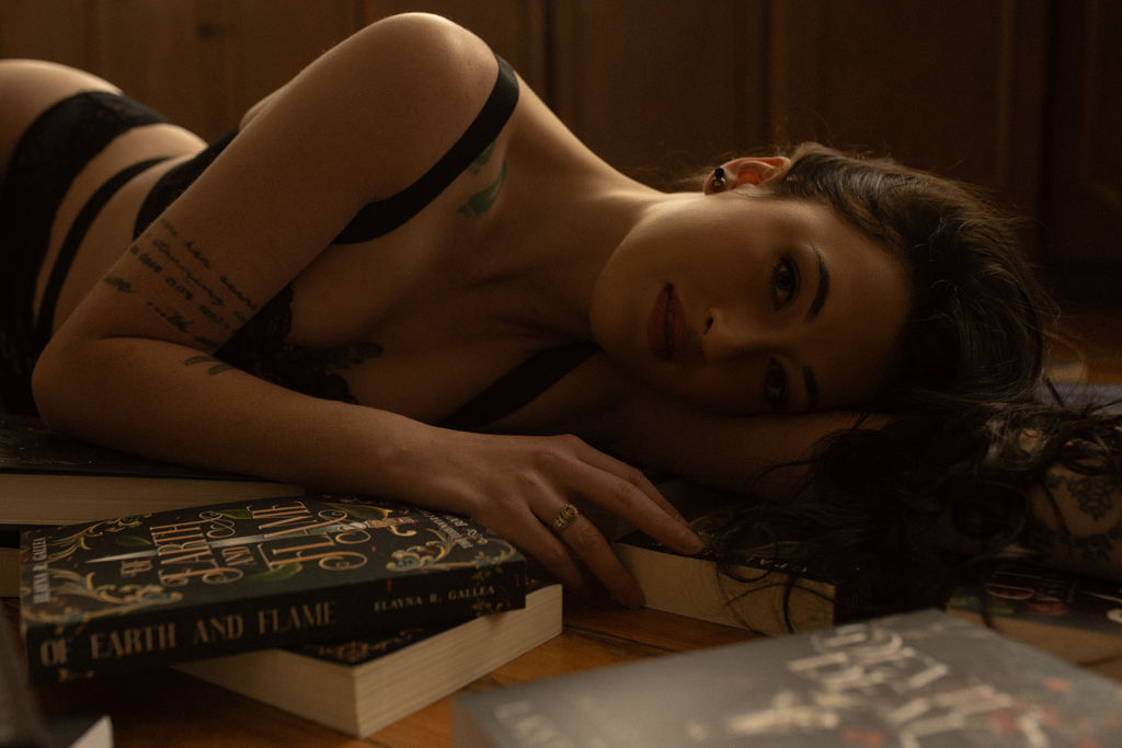 Woman lying on floor with books in boudoir 